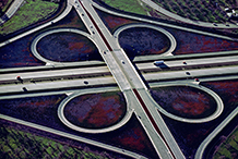 Freeway interchange with wild flowers.  1973